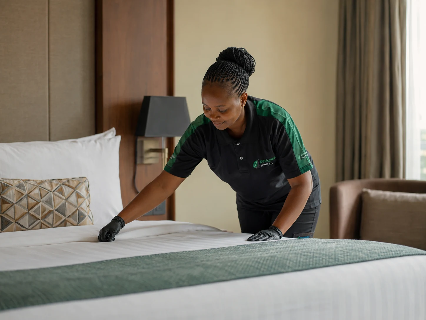 Pestorika hospitality cleaner preparing a hotel room